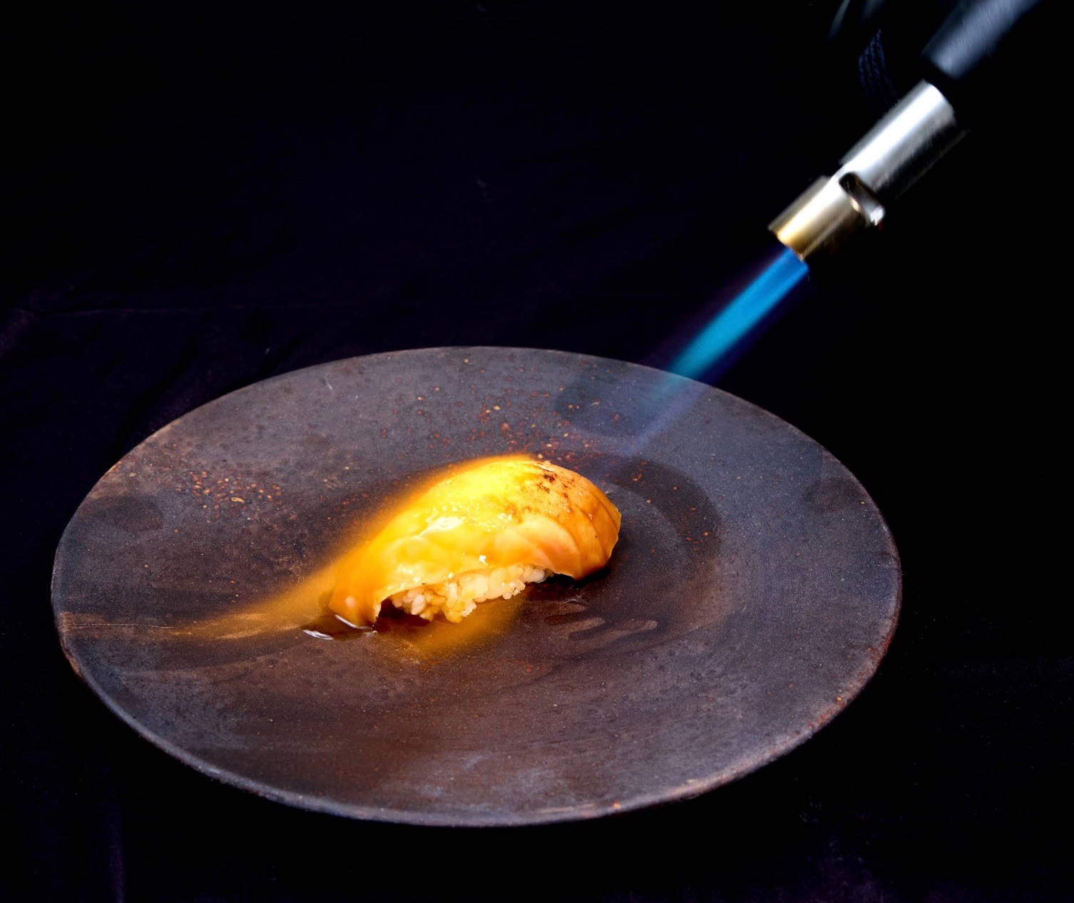 Client-supplied photograph of sushi being seared